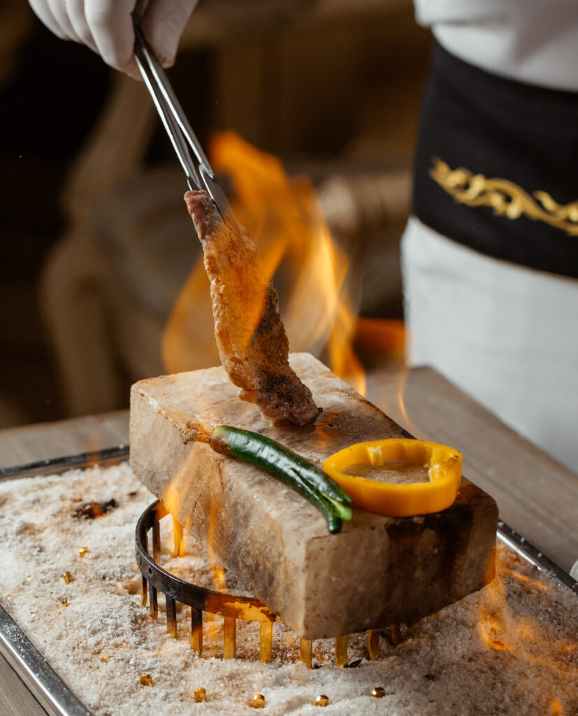 chef-cooking-beef-steak-piece-with-clip-stone-brick-fire