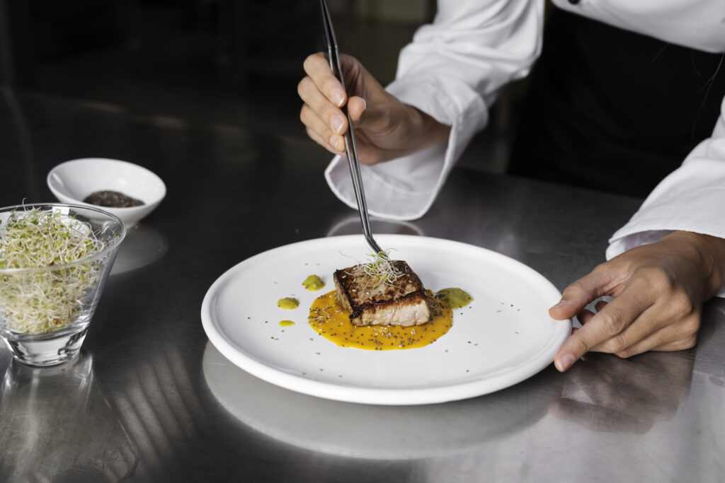 female-chef-kitchen-preparing-plate-steak
