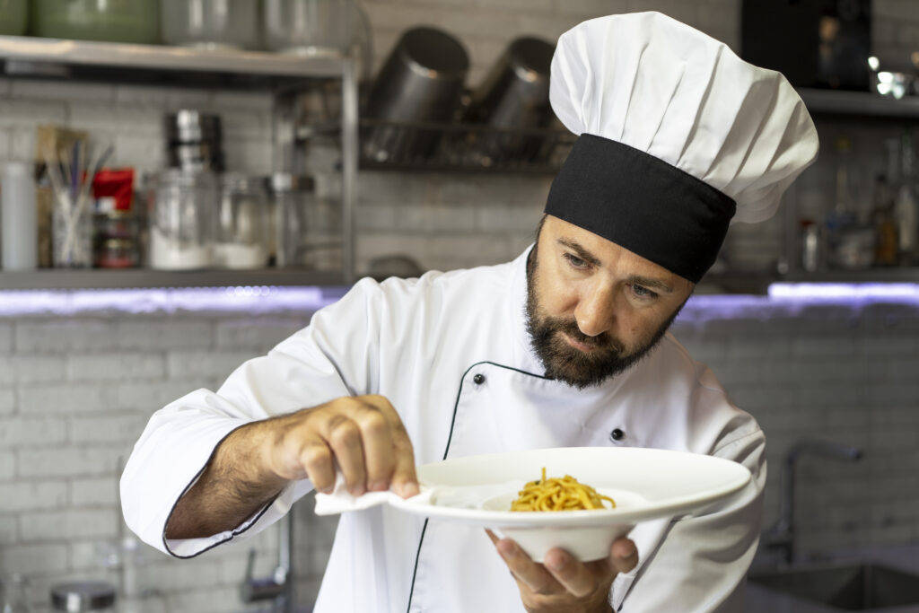 portrait-male-chef-kitchen-holding-plate-food