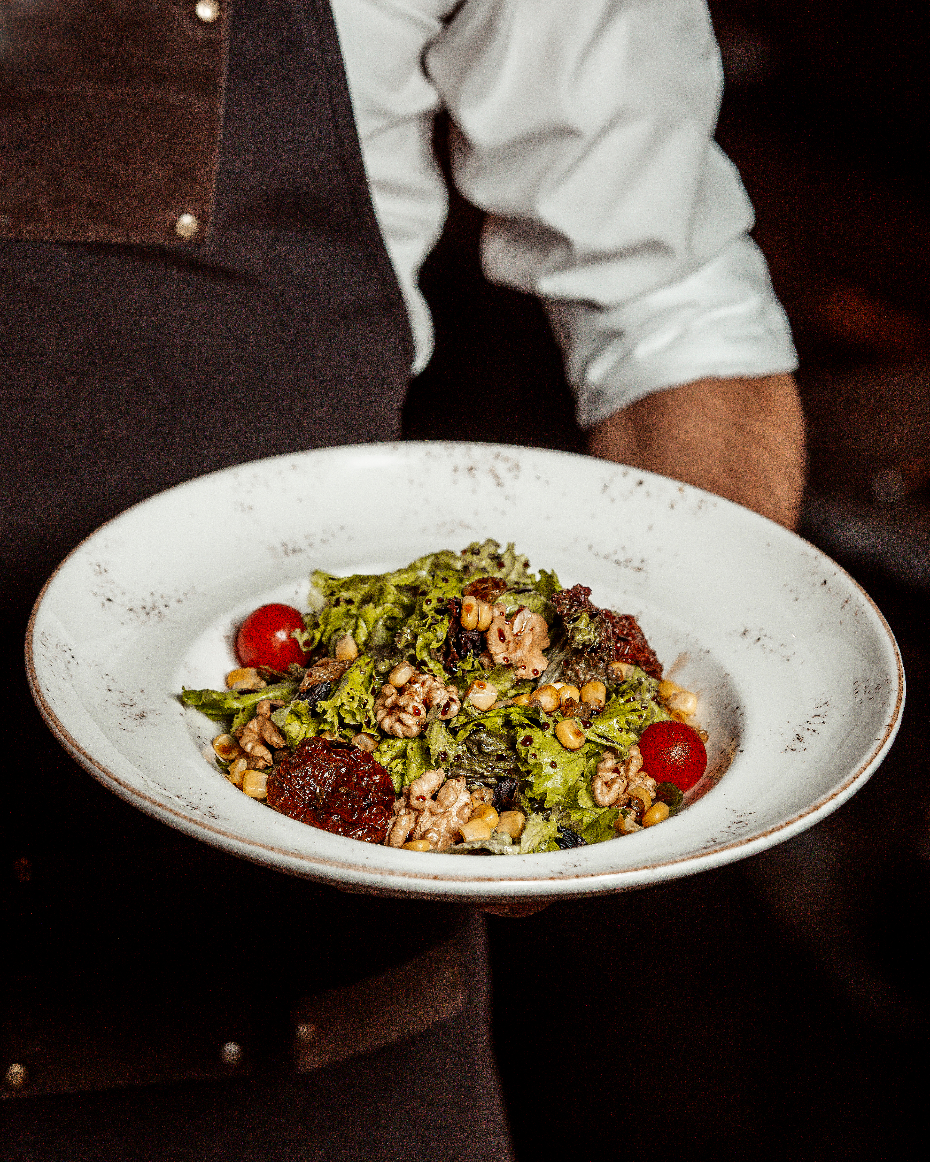 salad-with-corn-nuts-prunes-tomatoes