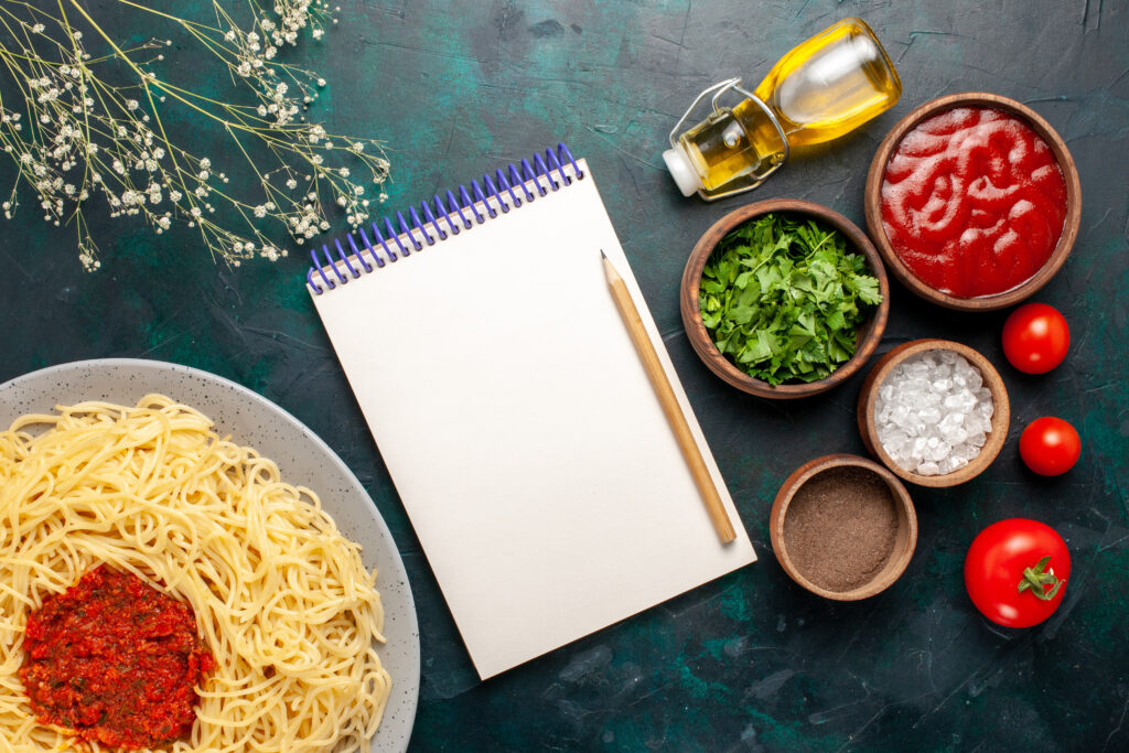 top-view-cooked-italian-pasta-with-meat-different-seasonings-dark-blue-surface